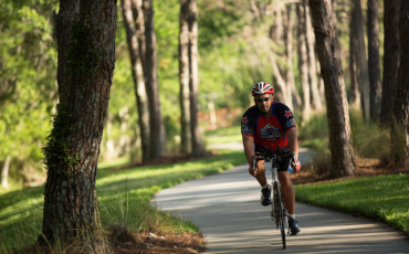Man riding bike through park