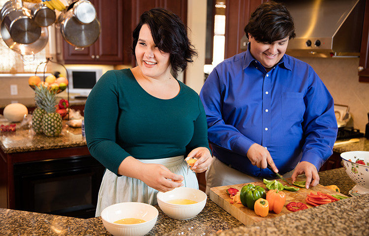 Man and woman in kitchen preparing food