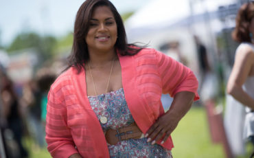 Happy woman in park with pink cardigan