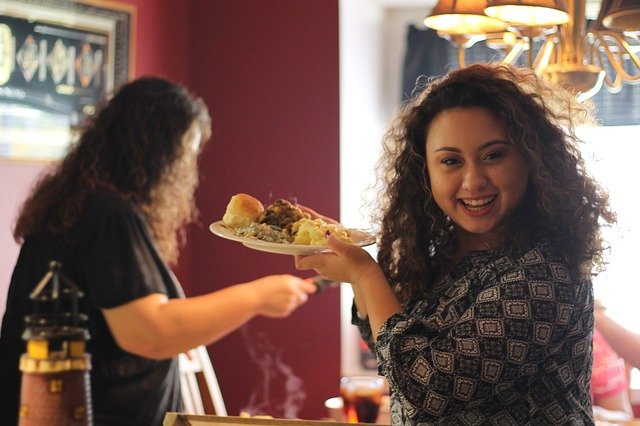 Blog image: Girl smiling holding food on Thanksgiving