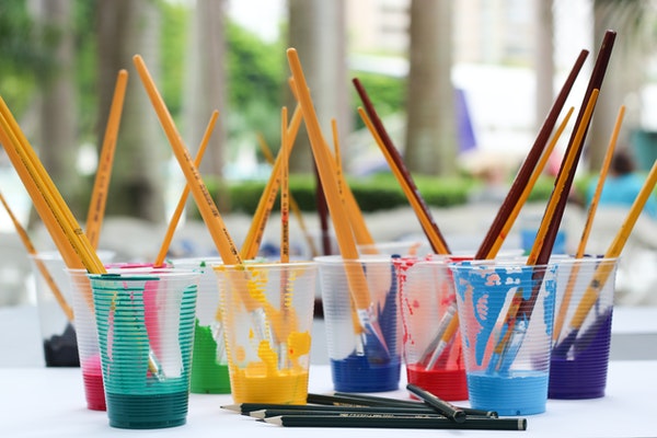 Paintbrushes in paint cups