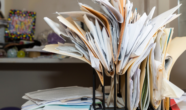 Messy clutter of files on a desk