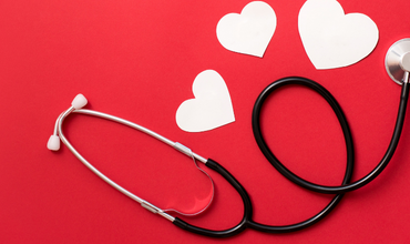 Stethoscope with white hearts to represent National Heart Month