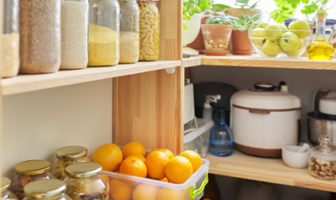 Kitchen cupboards with oranges and pantry staples