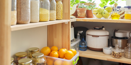 Kitchen cupboards with oranges and pantry staples