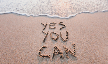 Staying Motivated: Yes You Can written in the sand on the beach