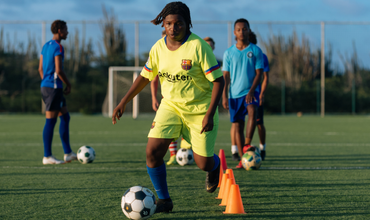 Teen playing soccer in a yellow uniform
