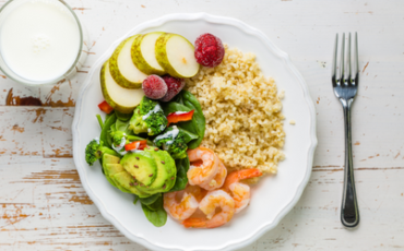 Portion controlled plate with whole grain rice, potatoes, shrimp, and avocado salad