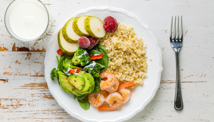 Portion controlled plate with whole grain rice, potatoes, shrimp, and avocado salad