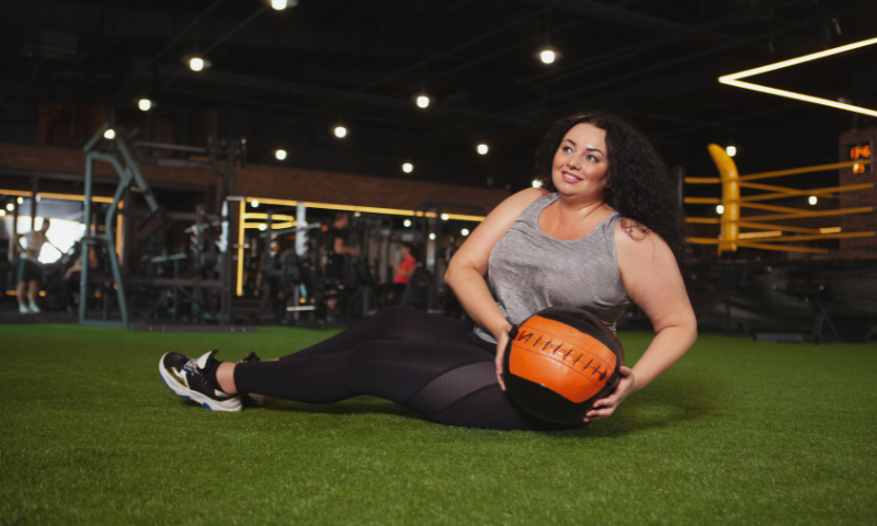 Woman using a medicine ball to workout with.