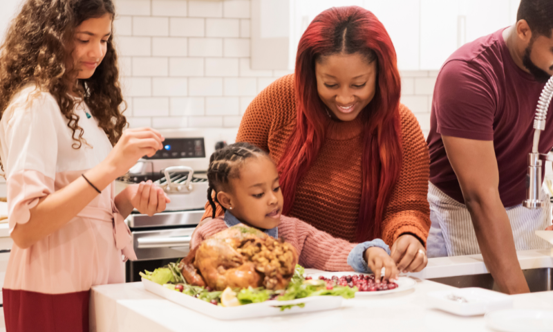 Family gathered in kitchen together for Thanksgiving holiday celebrations