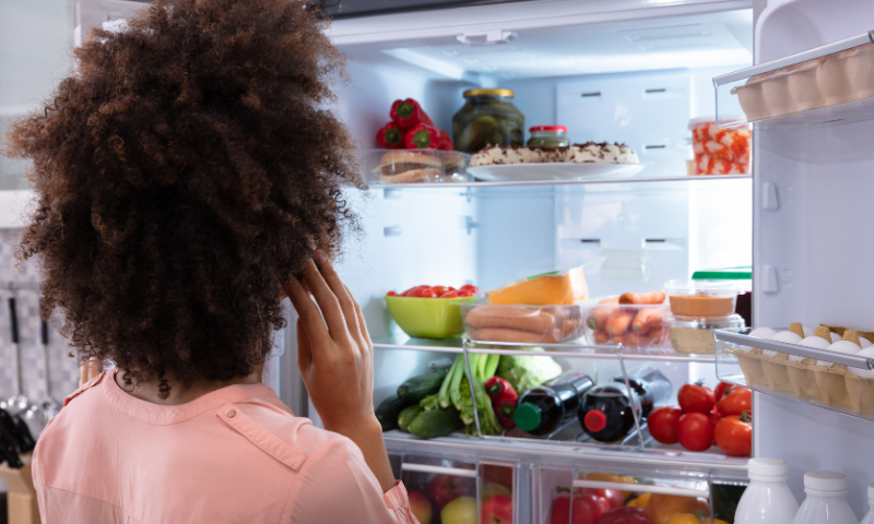 Woman in front of refrigerator